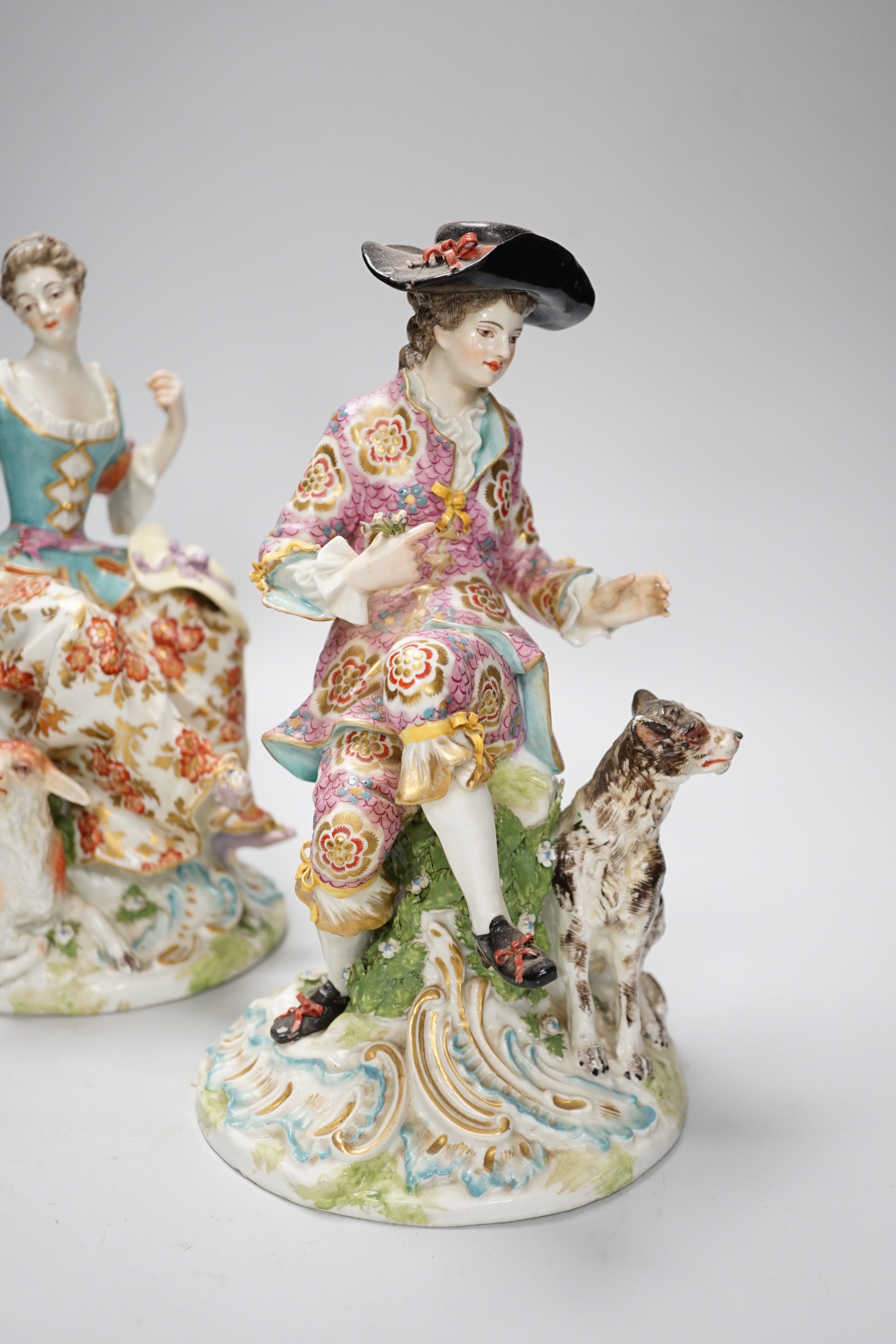 A pair of Chelsea Derby figures, seated male and female, 27.5cm
